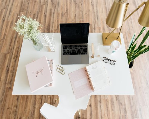 Modern clean office desk setup with notebook and coffee